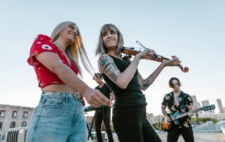 Modern band playing outdoors with violinist