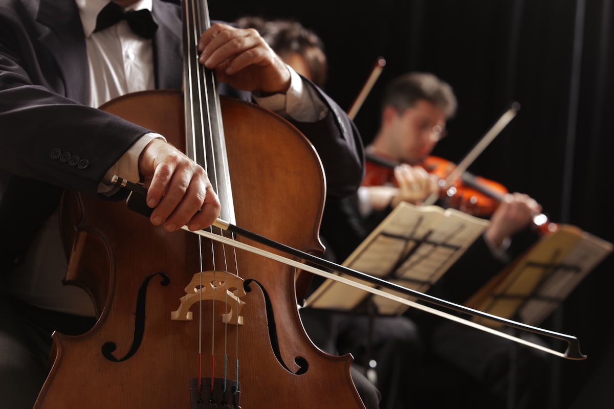 close up of cellist with violinist in background