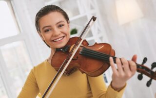 Cheerful girl playing a violin