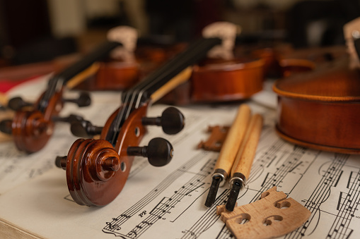 violins lying on top of music papers