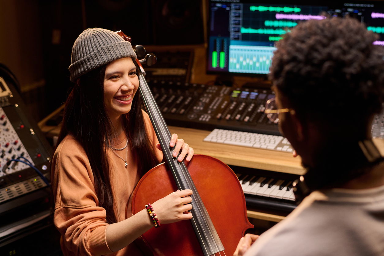 cello player talking with producer during studio session
