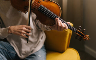 violinist testing a violin bow at home