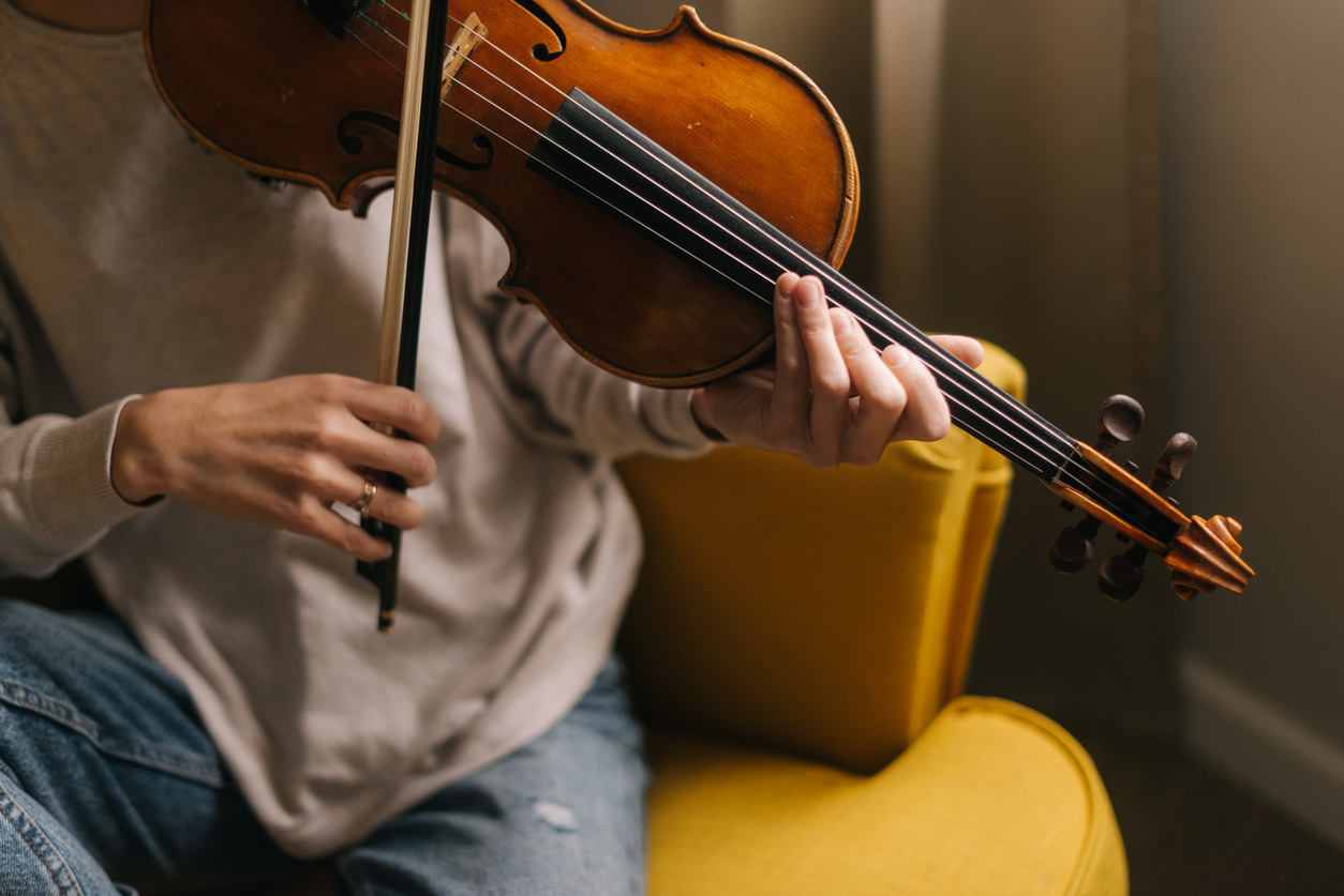 violinist testing a violin bow at home