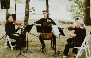 Cellist and two violin players playing for a wedding at Ramble Creek