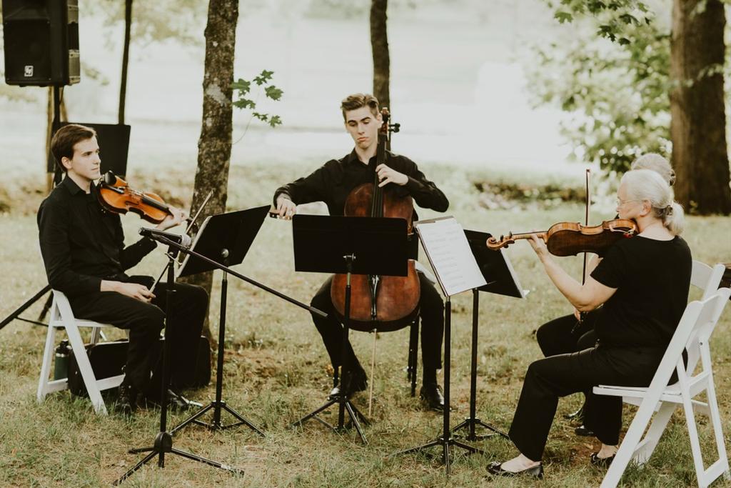 Cellist and two violin players playing for a wedding at Ramble Creek